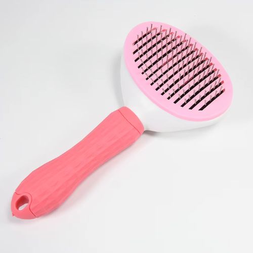 Une brosse pour chien rose à picots Acier inoxydable un poignée ergonomique conçu a démêle les nœuds et élimine les poils mortes