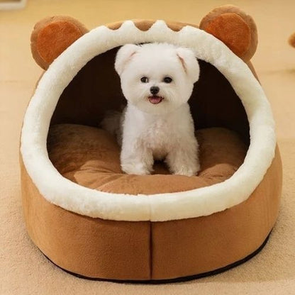 Petit chien blanc assis dans une niche chien intérieur en forme d’animal marron, offrant un espace douillet, sécurisé et amusant pour le confort de l’animal à la maison