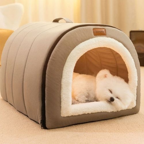 Petit chien blanc dormant paisiblement dans une niche chien interieur confortable et cosy de couleur grise avec tissu doux.