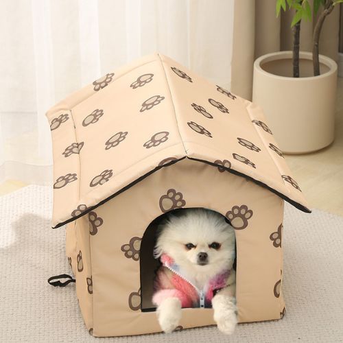 Chien assis calmement dans une niche pour chien extérieur beige, installée dans un salon moderne, avec motifs pattes et toit protecteur.