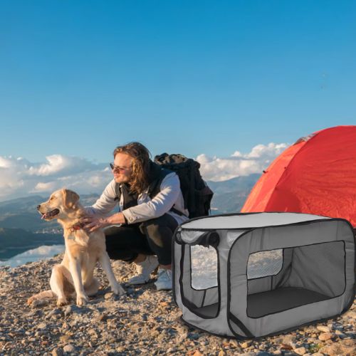 Niche pour chien pliable grise en toile respirante installée en pleine nature, avec un randonneur et son chien près d’une tente rouge en montagne, parfaite pour le camping et les aventures en plein air.